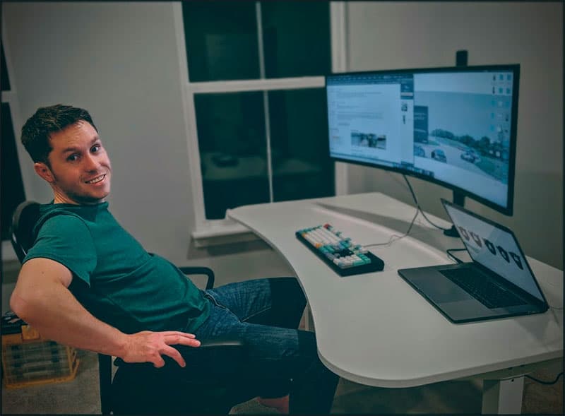 Schyler Manning at a computer desk in front of a large computer monitor