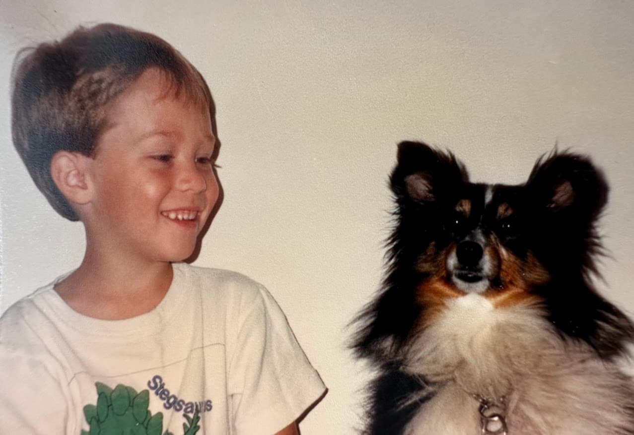 A young Schyler looking at his first dog, Raina